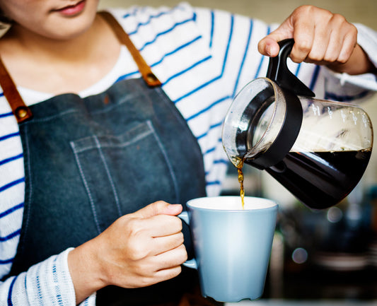 Woman pour a cup of coffee